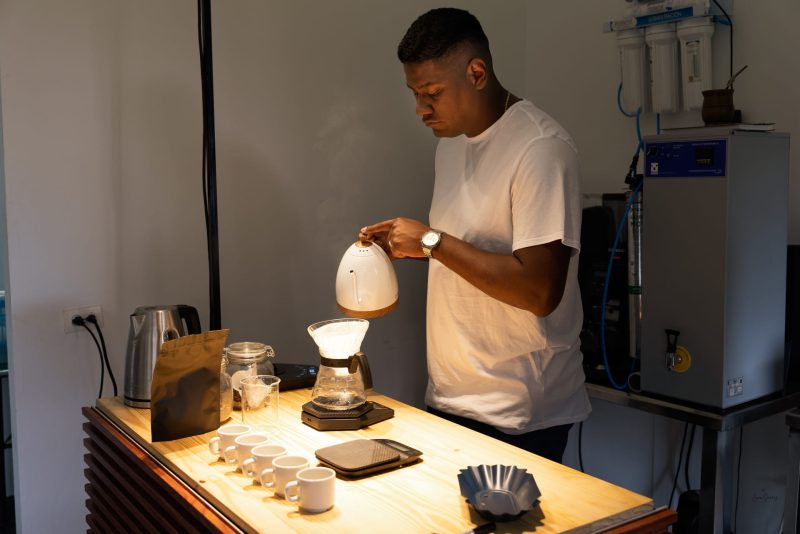 man making pour over coffee